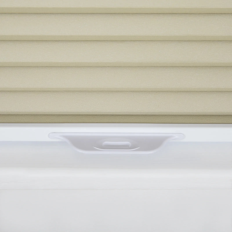 Photograph of textured beige horizontal window Blinds above a smooth white window frame featuring a subtle recessed pull handle