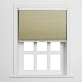 A textured beige cellular Blind partially covering a white window with six empty panes in a minimalist bright interior