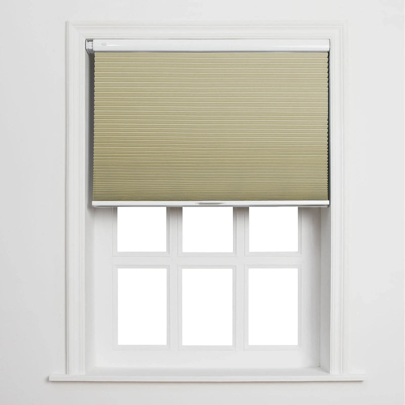 A textured beige cellular Blind partially covering a white window with six empty panes in a minimalist bright interior
