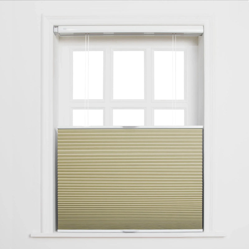 A tan pleated top-down bottom-up cellular Blind covers the lower portion of a white six-pane window with the top half exposed