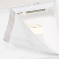 Close-up of a white textured fabric window blind or Roman shade panel showing the Velcro attachment to a top track system with a white beaded chain operator indoors