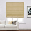 Beige Roman blind installed in a modern living room window above a white sofa with cream and grey accent pillows and a black and white floral artwork on the wall