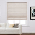 Photograph of a stylish living room featuring a white modern sofa, golden yellow and charcoal gray accent pillows, and a light beige linen Roman blind on the window next to a framed black and white floral art print