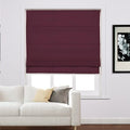 Photograph of a modern interior living room showcasing a burgundy roman blind over a window, a white sofa with cream and gray accent pillows, and black and white floral art on the adjacent wall