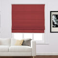 A dark red Roman blind in a white framed window next to a white sofa with cream and grey throw pillows and a black and white floral art print on the wall