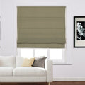 Modern living room featuring an olive green Roman blind covering a window, a white sofa with cream and gray throw pillows, and a framed black and white orchid print