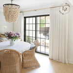 Liz Linen Pleated Curtains in a bright dining room with woven chairs and black-framed French doors