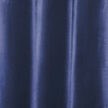 Photograph of deep indigo blue fabric showcasing subtle vertical folds, a textured weave, and shimmering highlights along the drapes