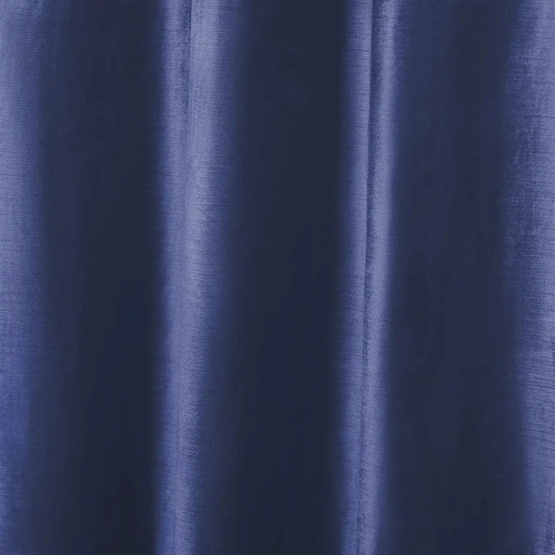 Photograph of deep indigo blue fabric showcasing subtle vertical folds, a textured weave, and shimmering highlights along the drapes
