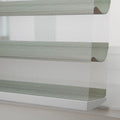 Modern sheer horizontal zebra window Blinds showcasing alternating textured sage green and sheer white fabric stripes with a clean white bottom rail