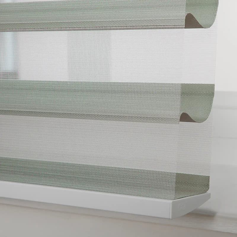 Modern sheer horizontal zebra window Blinds showcasing alternating textured sage green and sheer white fabric stripes with a clean white bottom rail