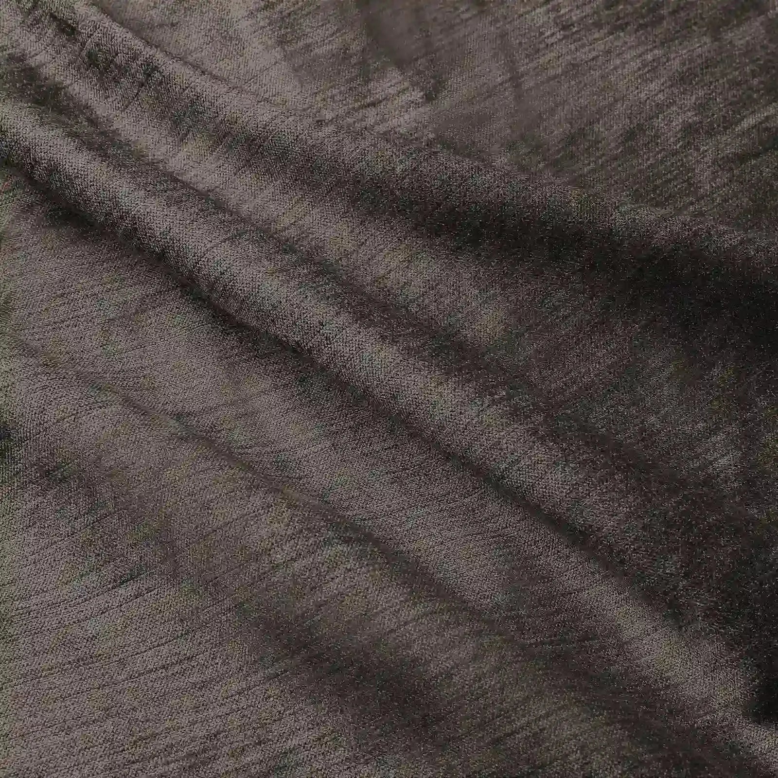 Photograph of dark metallic bronze textured fabric with subtle slubs and soft undulating folds creating depth