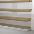 Photograph of a modern zebra window Blind featuring alternating sheer white and textured tan horizontal stripes with a prominent white bottom rail
