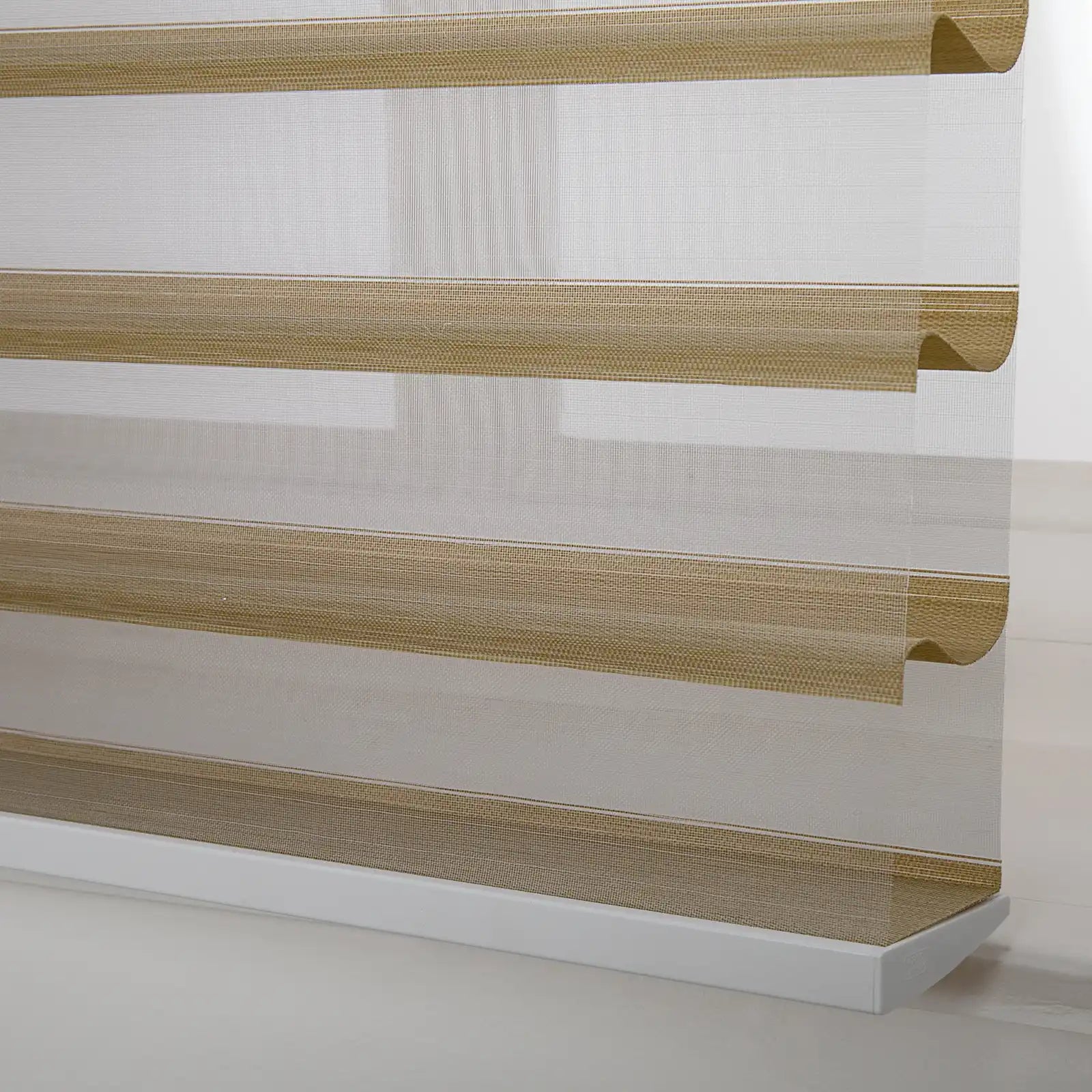 Photograph of a modern zebra window Blind featuring alternating sheer white and textured tan horizontal stripes with a prominent white bottom rail