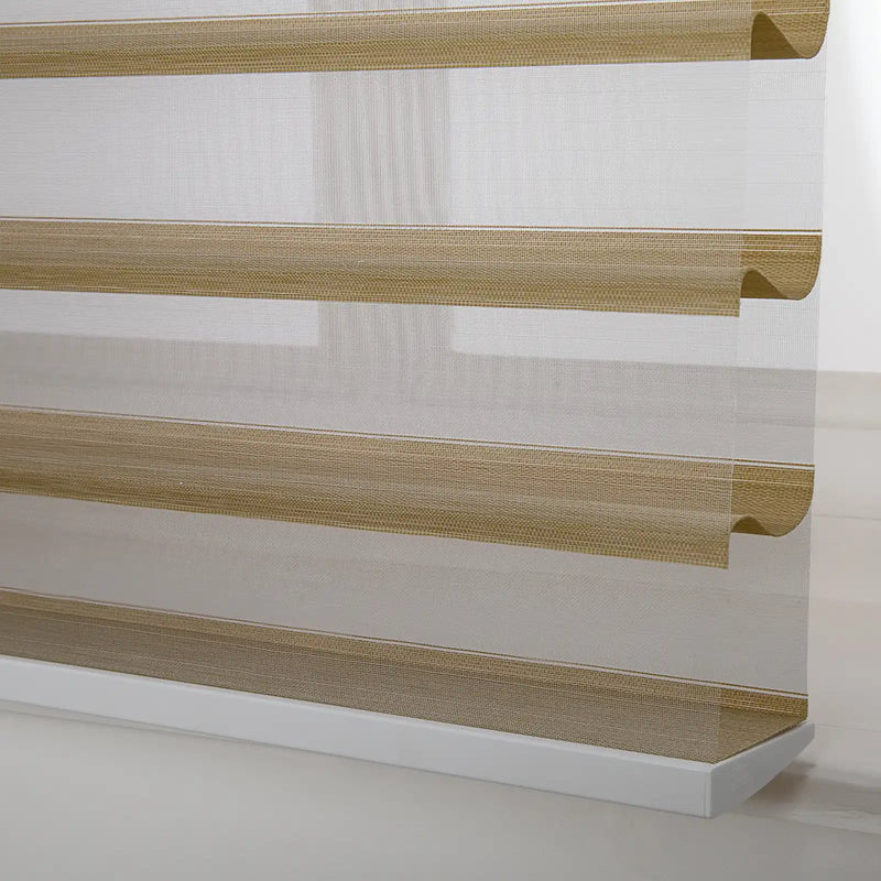 Photograph of a modern zebra window Blind featuring alternating sheer white and textured tan horizontal stripes with a prominent white bottom rail