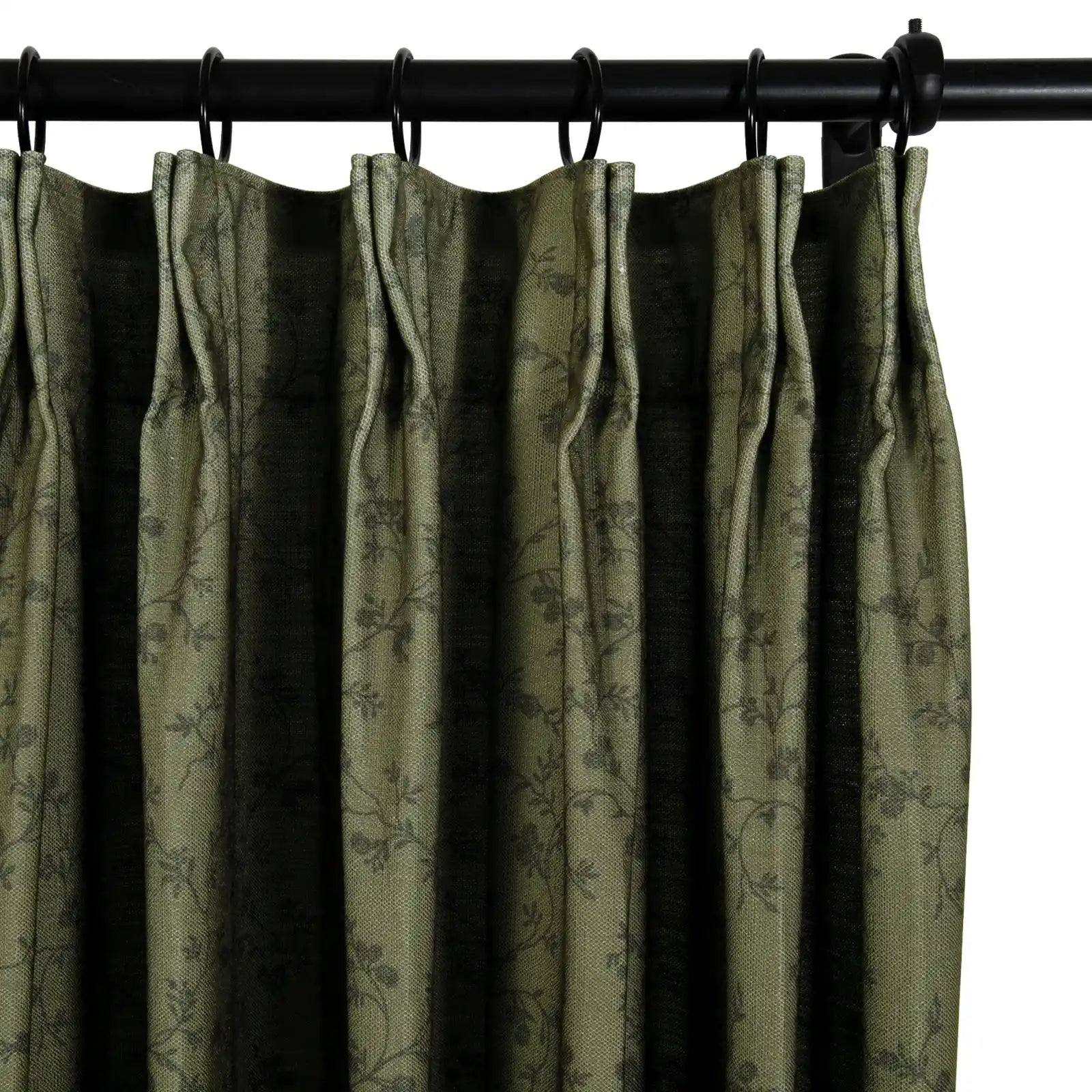 A richly textured olive green curtain panel featuring a subtle dark floral vine pattern suspended from a black metal rod with rings