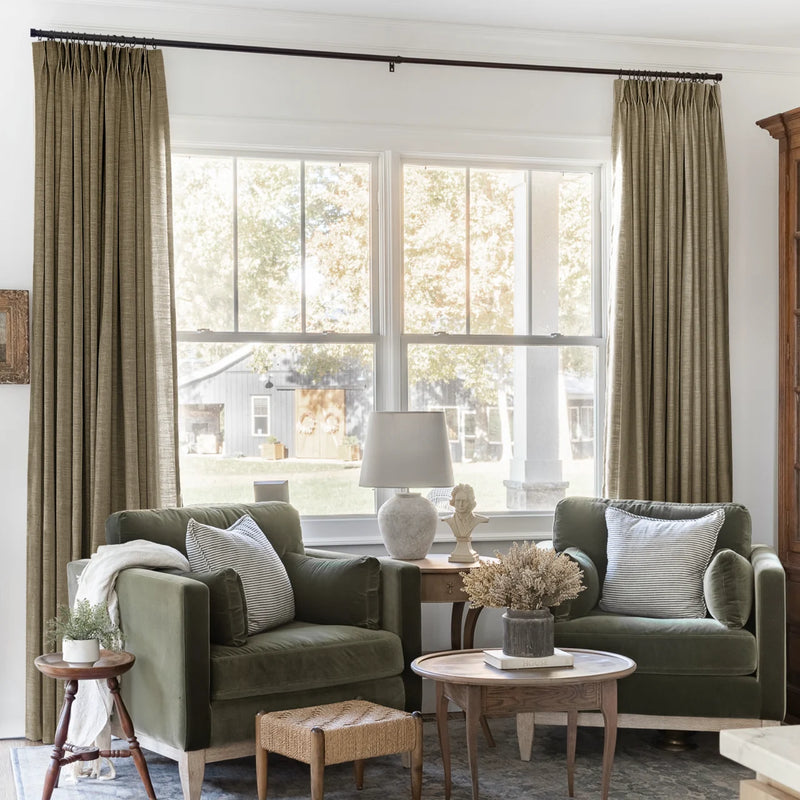 Oak Dim Gray Liz Linen Pleated Curtains framing a green sofa beneath a wide sunlit window