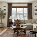 Oak Dim Gray Liz Linen Pleated Curtains in a living room with a white sectional sofa and gallery wall