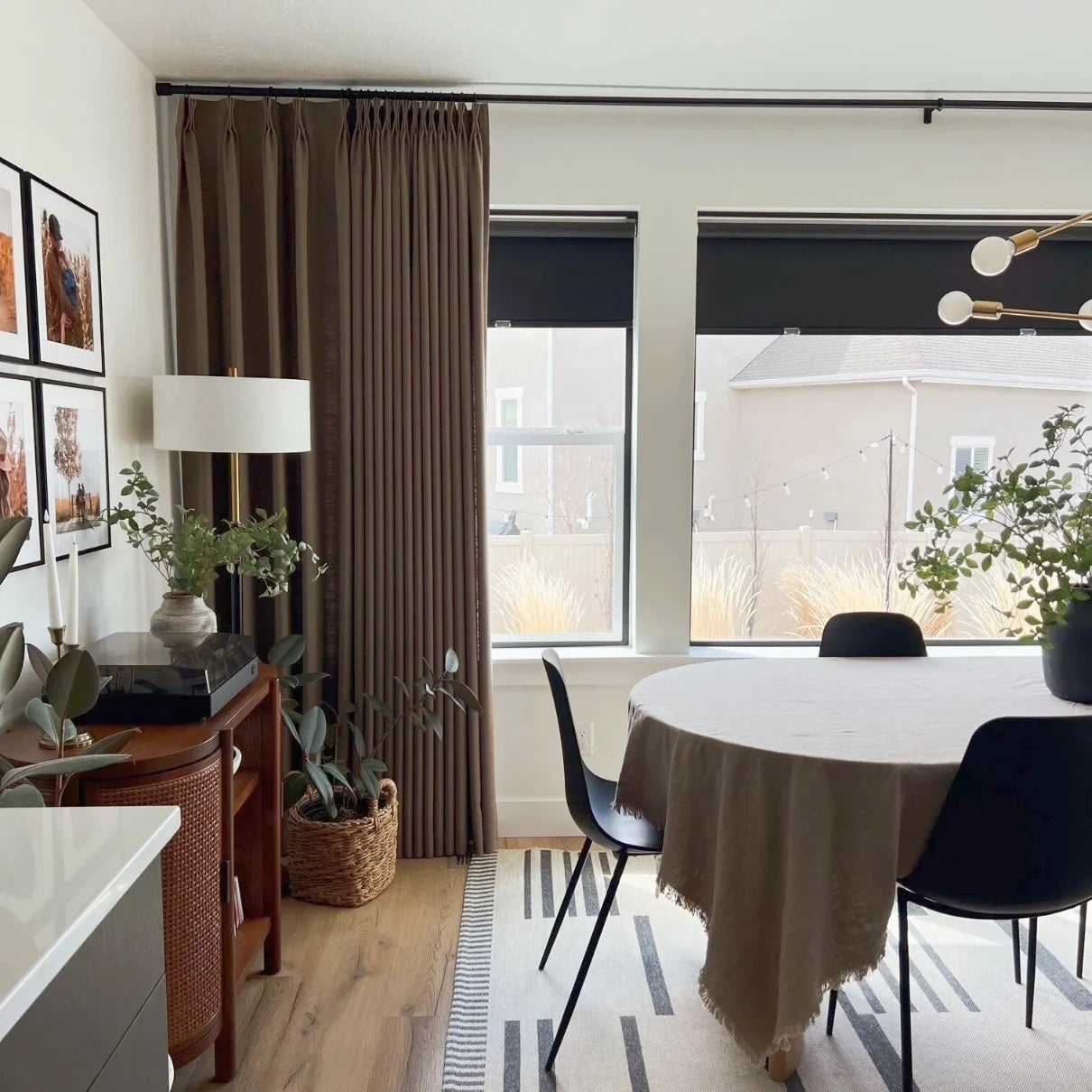 Oak Dim Gray Liz Linen Pleated Curtains around windows beside a round dining table and black chairs