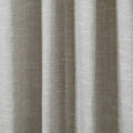Photograph of light greige textured fabric displaying distinct vertical pleats and a fine central seam