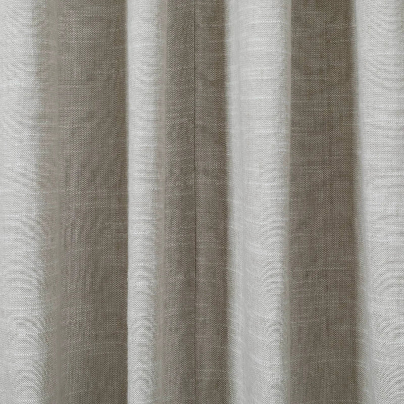 Photograph of light greige textured fabric displaying distinct vertical pleats and a fine central seam