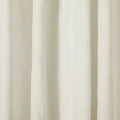 Close-up of draped off-white textured fabric showing subtle vertical folds and a natural woven weave