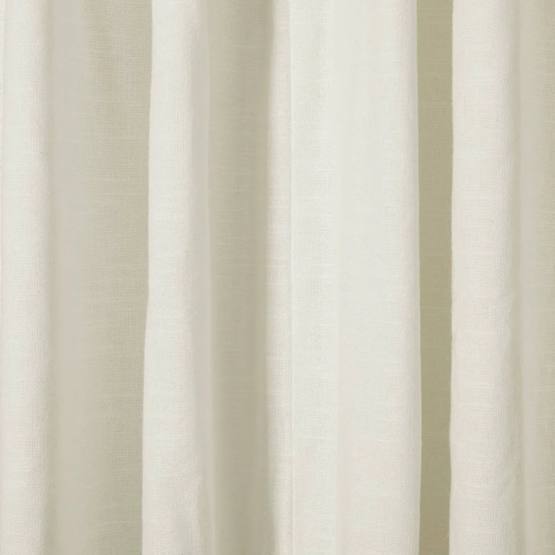 Close-up of draped off-white textured fabric showing subtle vertical folds and a natural woven weave