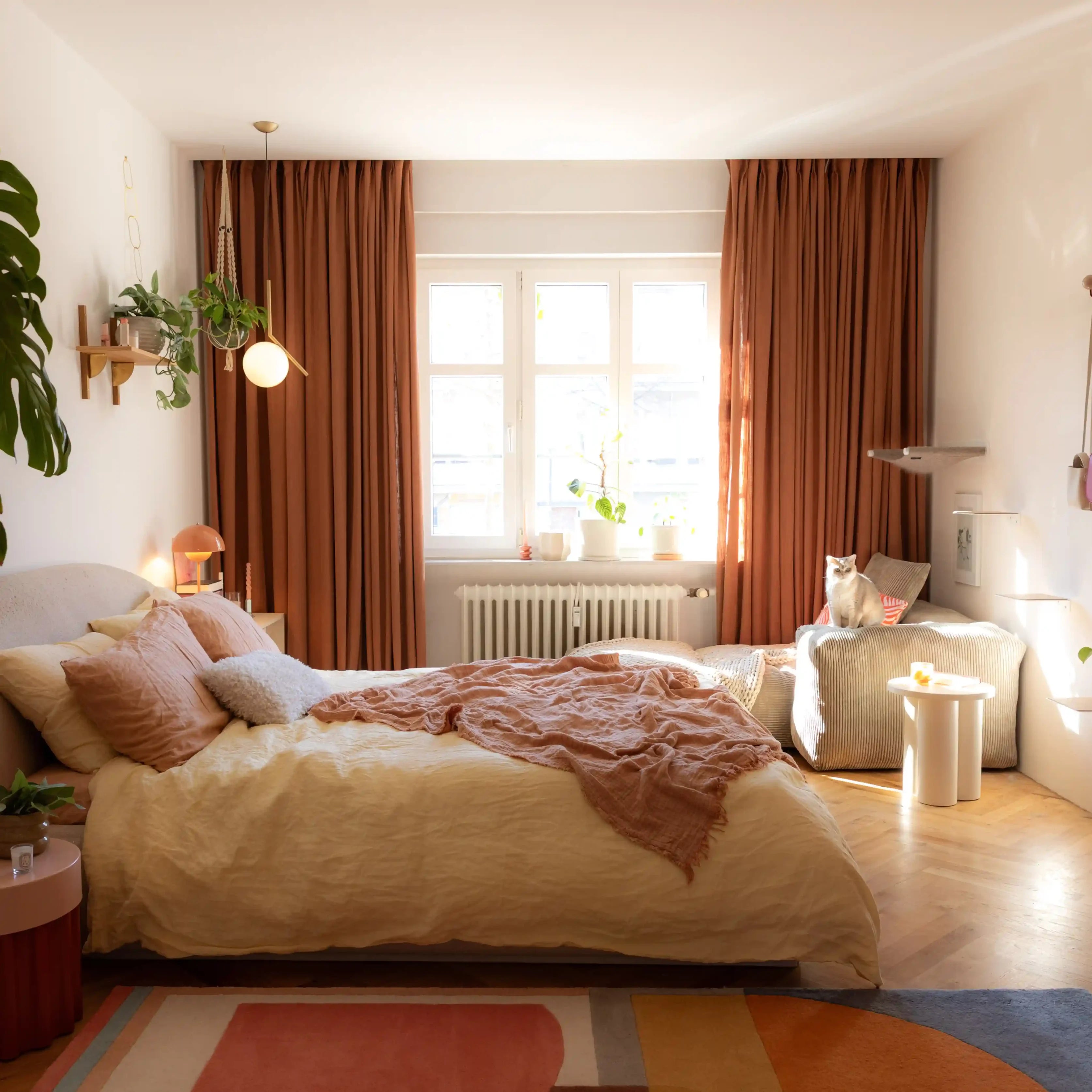 Orange Copper Liz linen curtains viewed at an angle in a softly styled room with natural daylight