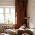 Orange Copper Liz linen curtains showing the lower drape and pooling folds near the floor