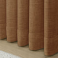 Orange Copper Liz linen curtains drawn partly across the window with filtered light revealing the weave