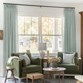 Pale Blue Aqua Liz linen curtains framing a bright window in a balanced full-length interior view