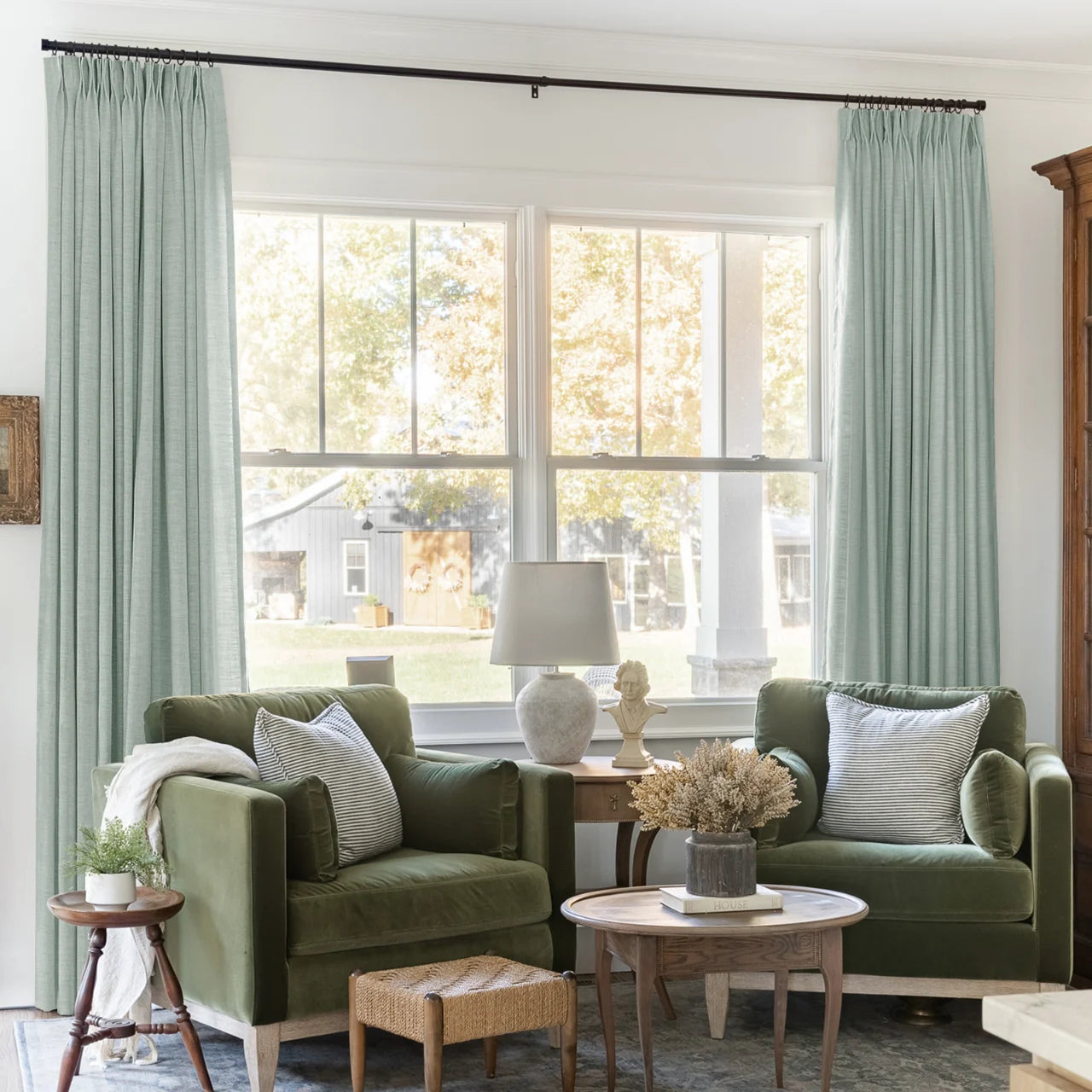 Pale Blue Aqua Liz linen curtains framing a bright window in a balanced full-length interior view