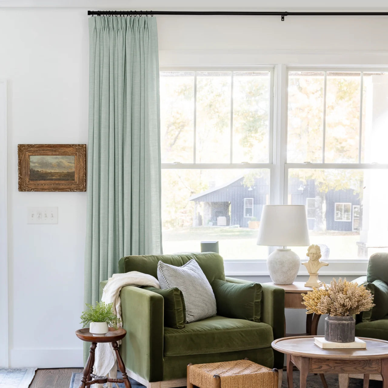 Pale Blue Aqua Liz linen curtains shown closer beside a sunlit window with smooth vertical folds
