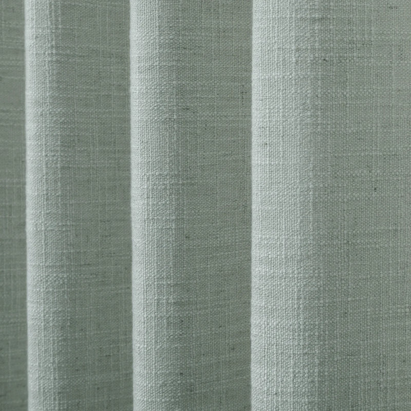 Pale Blue Aqua Liz linen curtains drawn partly across the window with filtered light revealing the weave