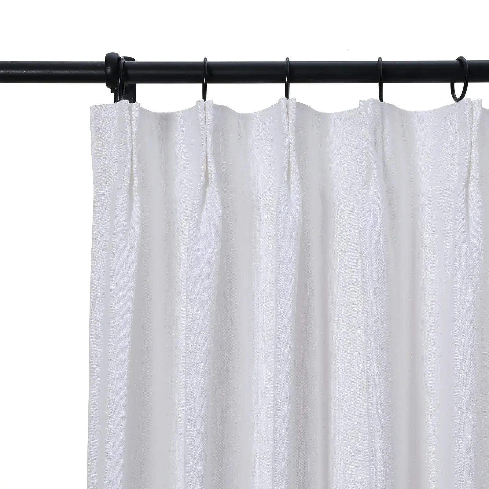 White textured fabric curtain with pleated top hanging from a black metal rod with black rings against a white background