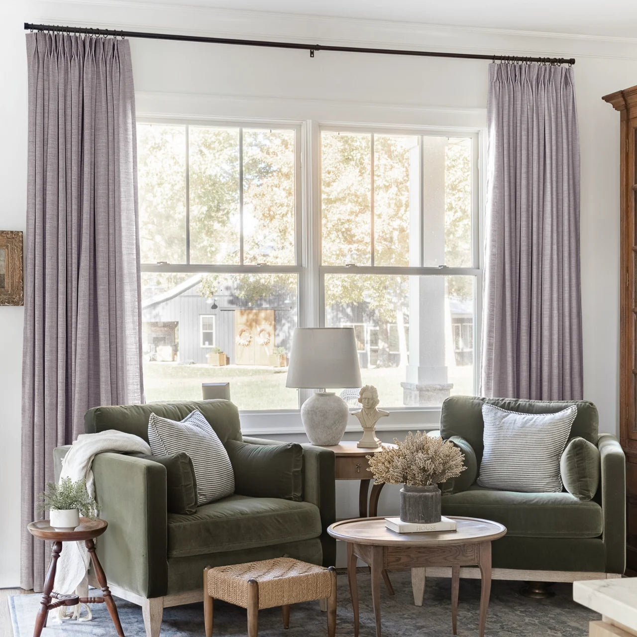 Parchment Liz linen curtains framing a bright window in a balanced full-length interior view