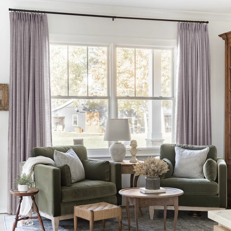 Parchment Liz linen curtains framing a bright window in a balanced full-length interior view
