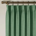 Peacock Liz linen curtains viewed at an angle in a softly styled room with natural daylight