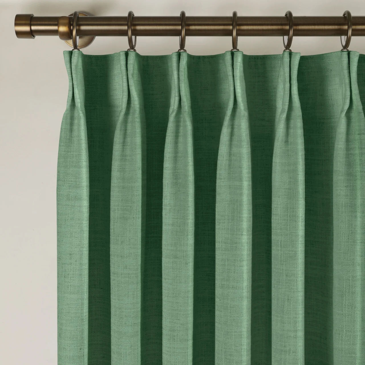 Peacock Liz linen curtains viewed at an angle in a softly styled room with natural daylight