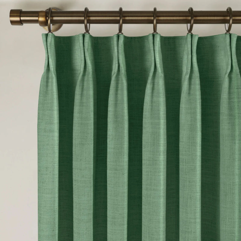 Peacock Liz linen curtains viewed at an angle in a softly styled room with natural daylight
