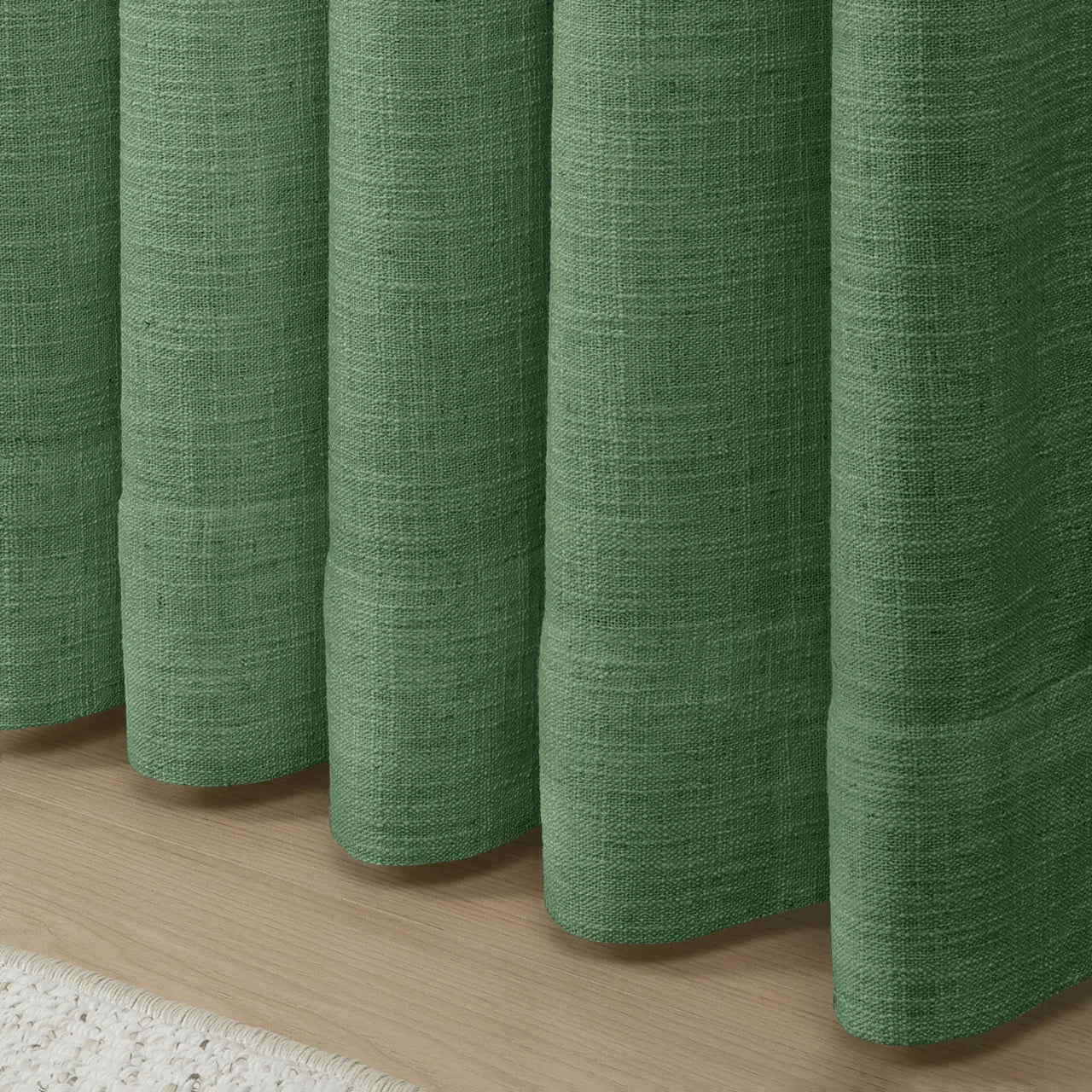 Peacock Liz linen curtains showing the lower drape and pooling folds near the floor