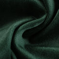 Emerald green plush fabric featuring a rich velvety texture and dynamic folds illuminated by soft highlights and shadows