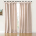 A pair of natural beige faux linen tab top curtains featuring decorative bows on a black rod in a room with a white wall, hardwood floor, and a small framed landscape painting