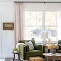 Pink Lemonade Liz linen curtains shown closer beside a sunlit window with smooth vertical folds