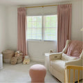Pink Lemonade Liz linen curtains viewed at an angle in a softly styled room with natural daylight