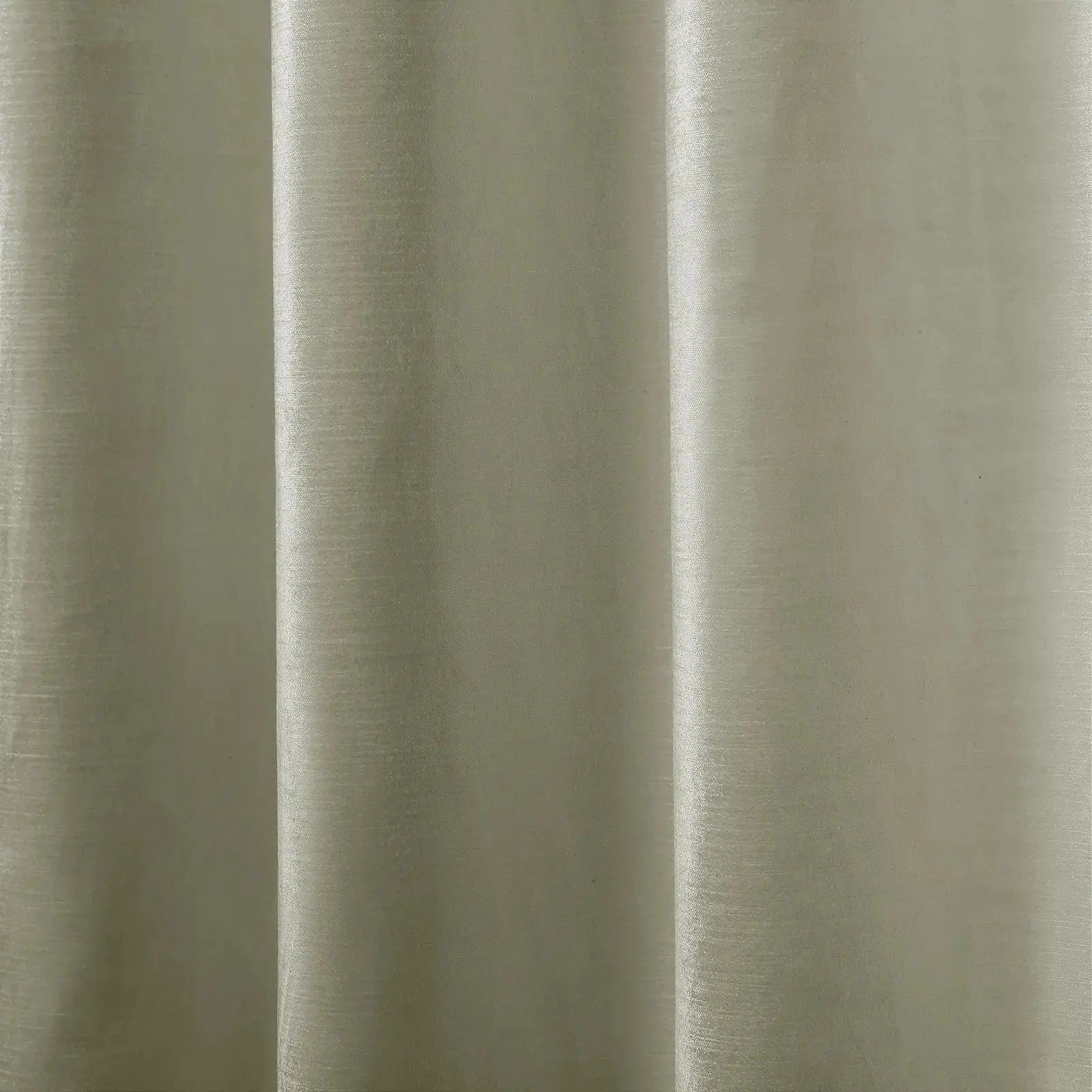 Close-up photograph of a light greige textile featuring a subtle textured weave and soft vertical drapes creating gentle highlights and shadows