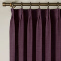 Plum Liz linen curtains viewed at an angle in a softly styled room with natural daylight