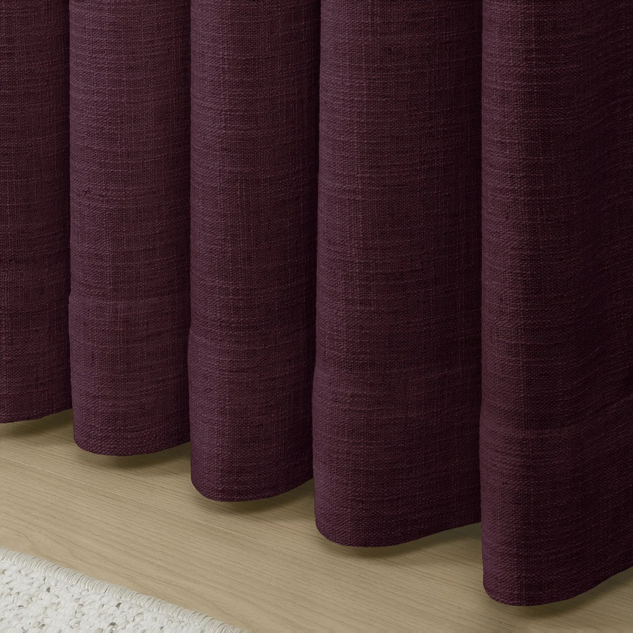 Plum Liz linen curtains showing the lower drape and pooling folds near the floor
