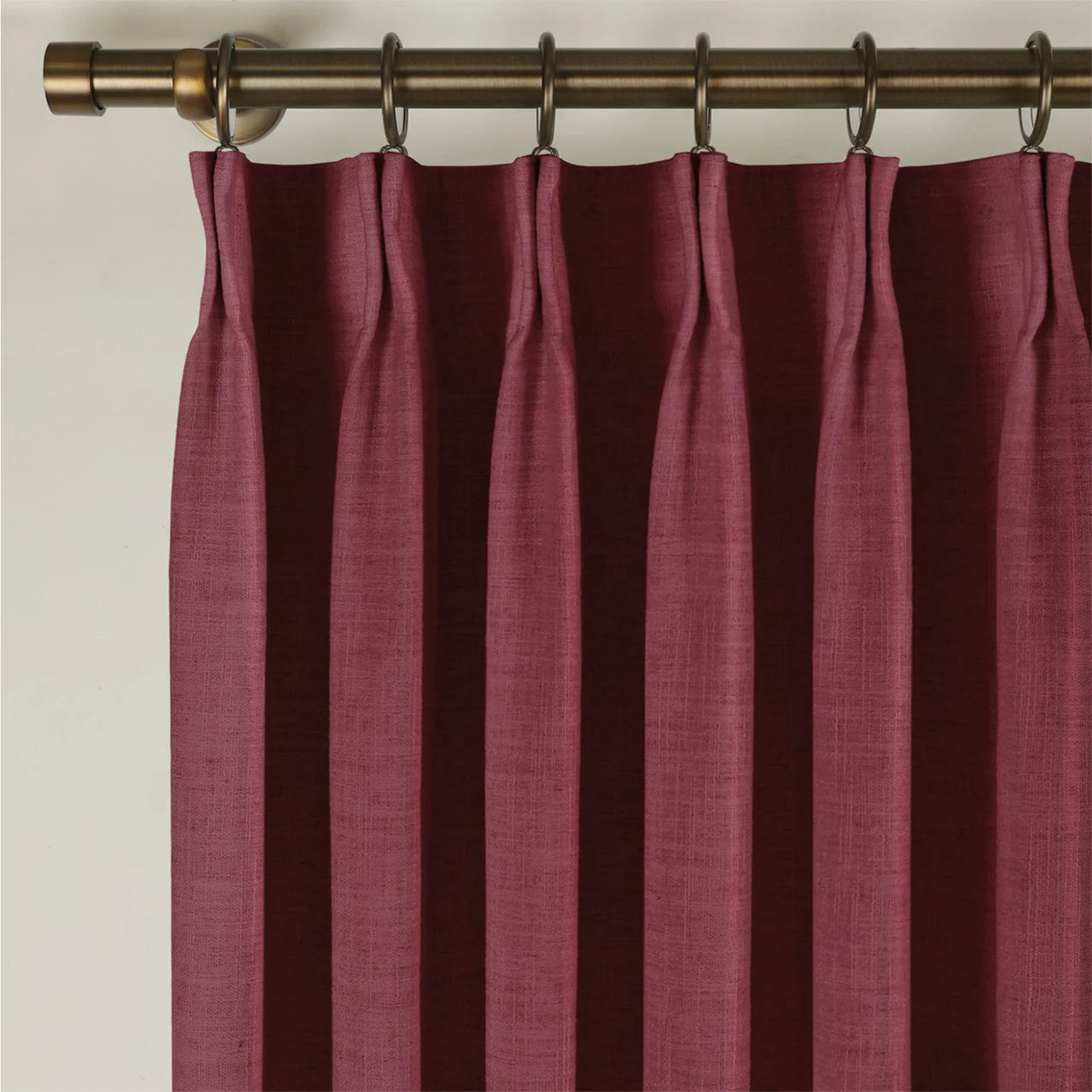 Red Wine Liz linen curtains viewed at an angle in a softly styled room with natural daylight