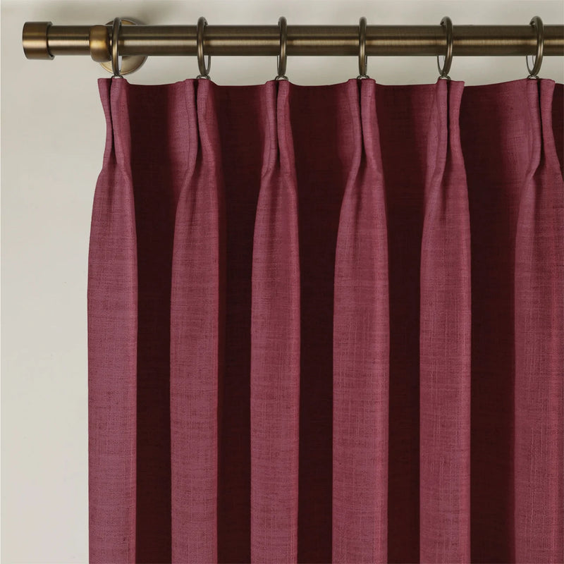 Red Wine Liz linen curtains viewed at an angle in a softly styled room with natural daylight